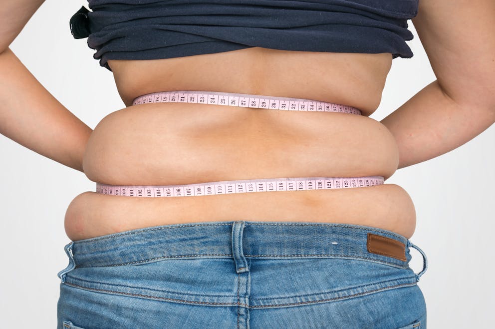 Women measuring back fat