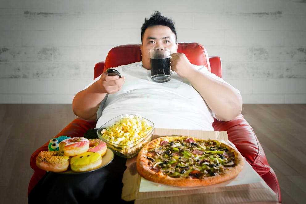 Man sitting on a chair with junk food