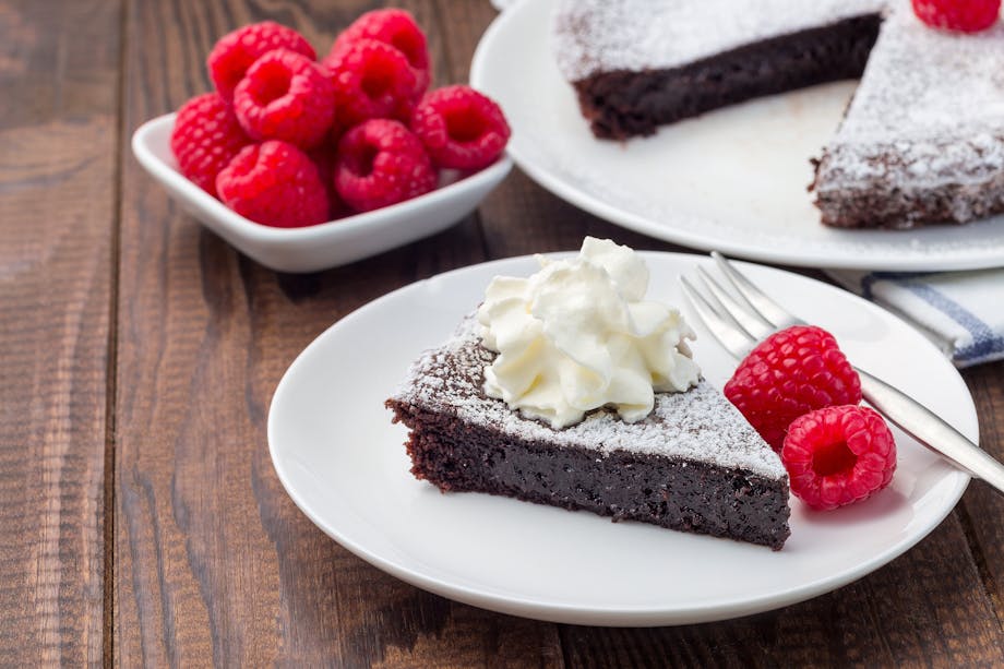 Whipped cream and raspberries on cake