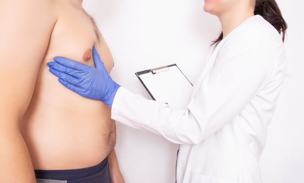 Doctor checking mans chest