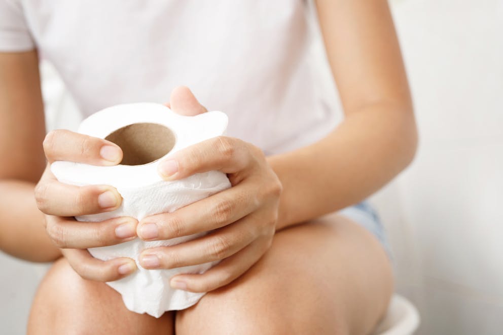 Woman holding toilet paper