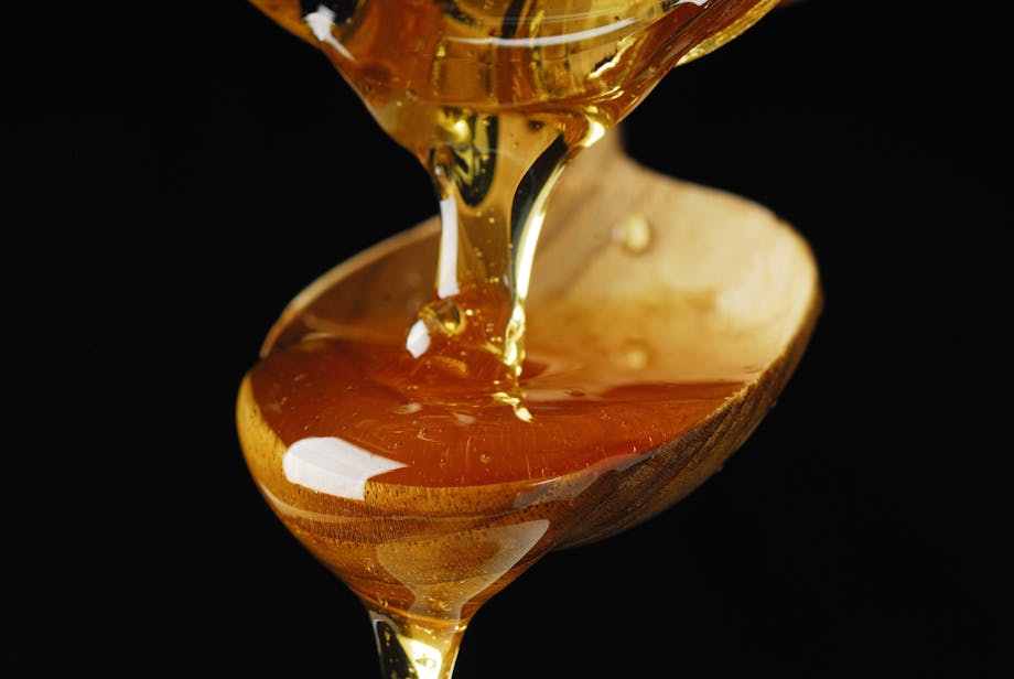 Maple syrup over a spoon