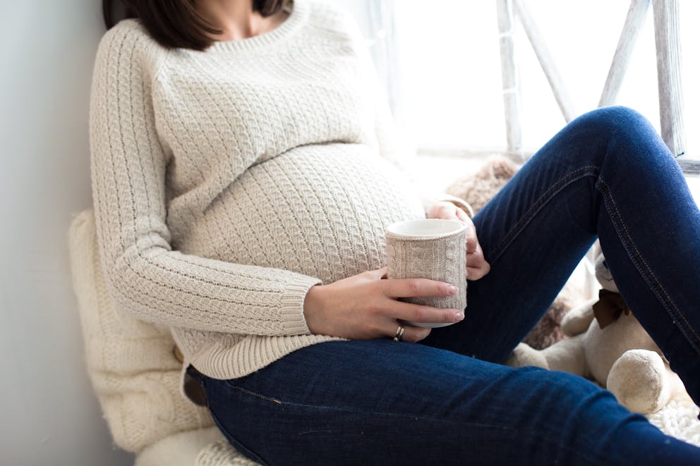 Pregnant woman holding a cup