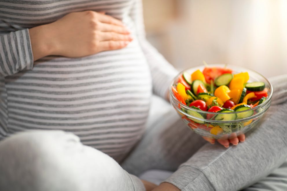 Pregnant woman with salad