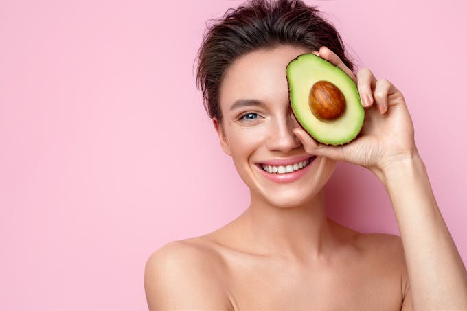 Woman holding avocado