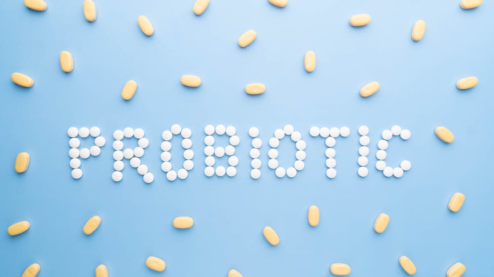 Probiotic supplements on blue background