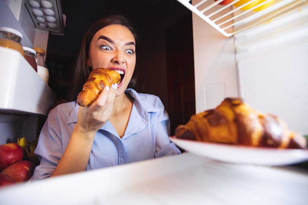 Woman eating a cheat meal