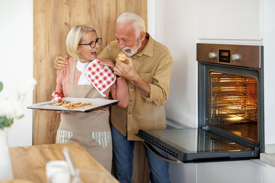 Senior couple baking cookies