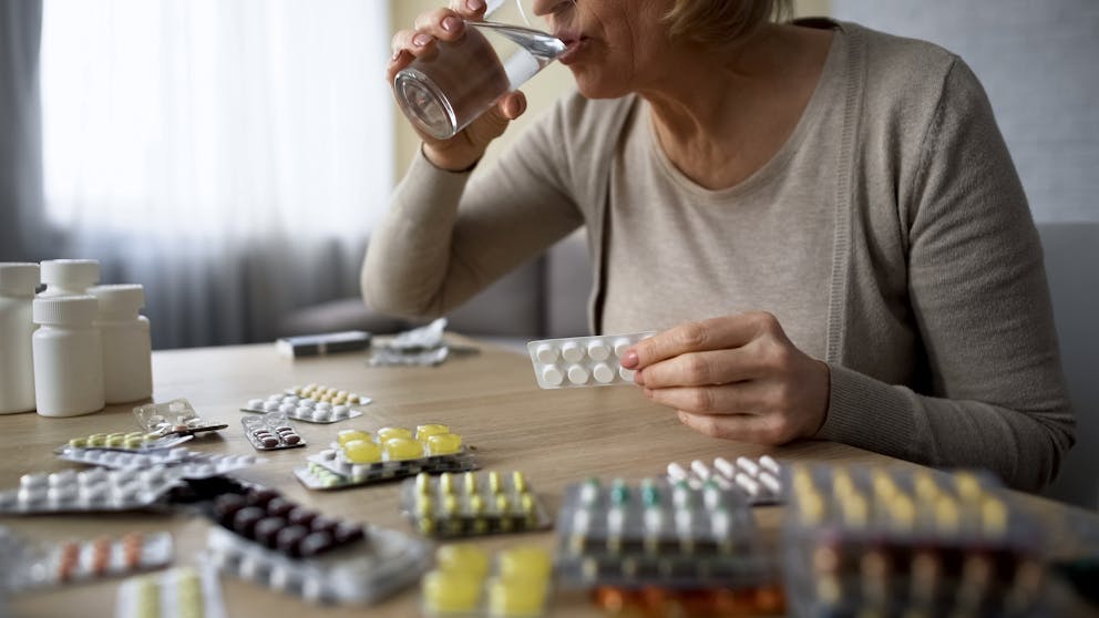 woman taking too many supplements