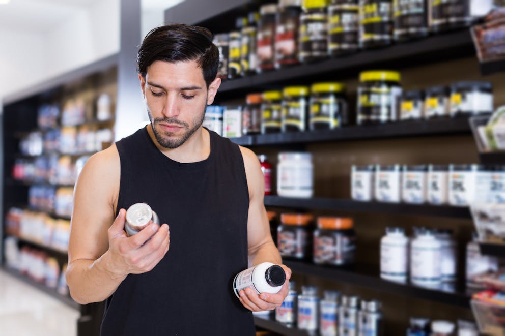 Man comparing supplements