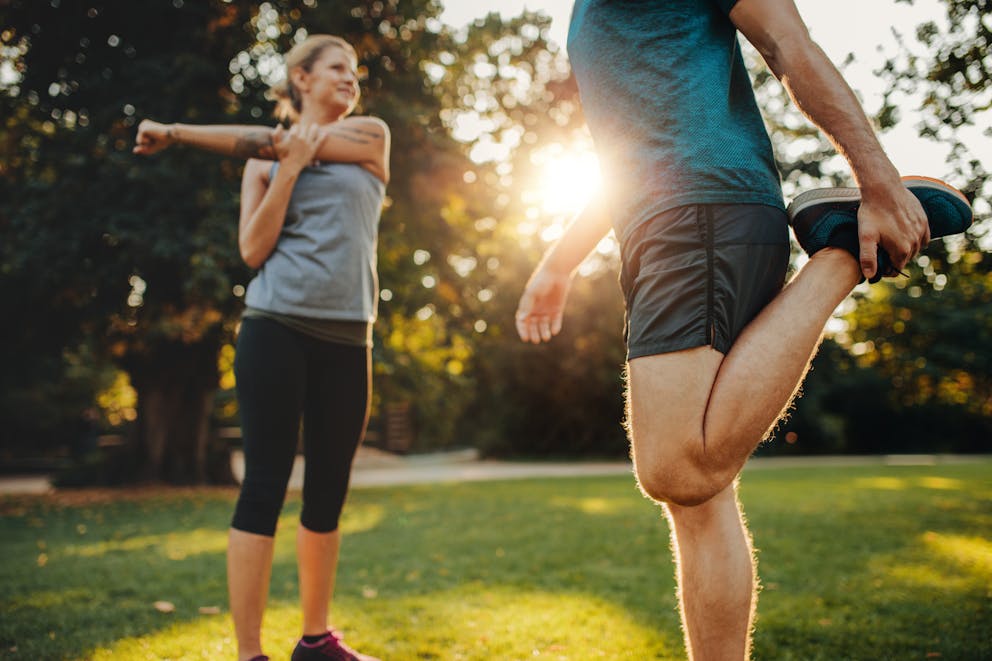 Athletic couple doing stretching exercises