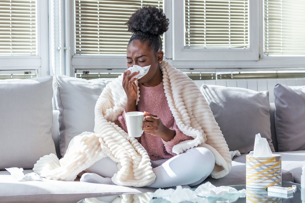 Woman sick and drinking tea