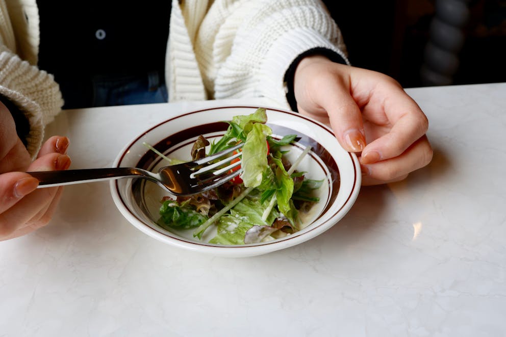 Woman eating a small salad