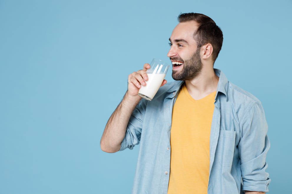Happy man drinking milk