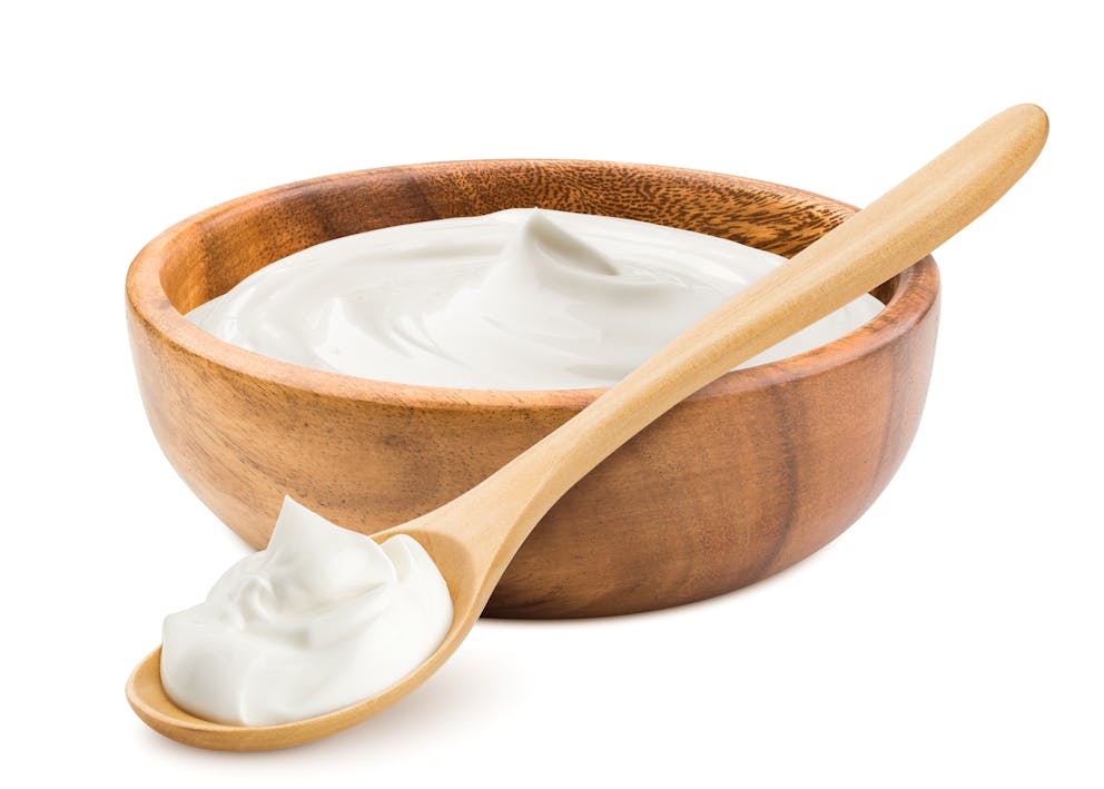 Sour cream in a wooden bowl