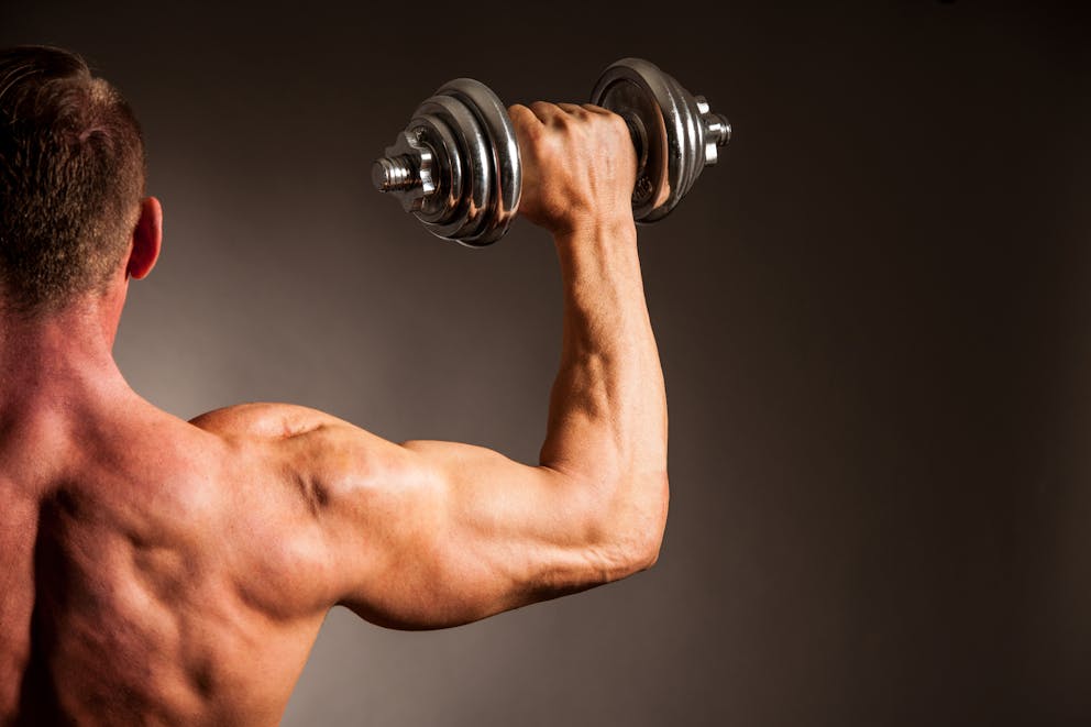 Muscular man holding weight