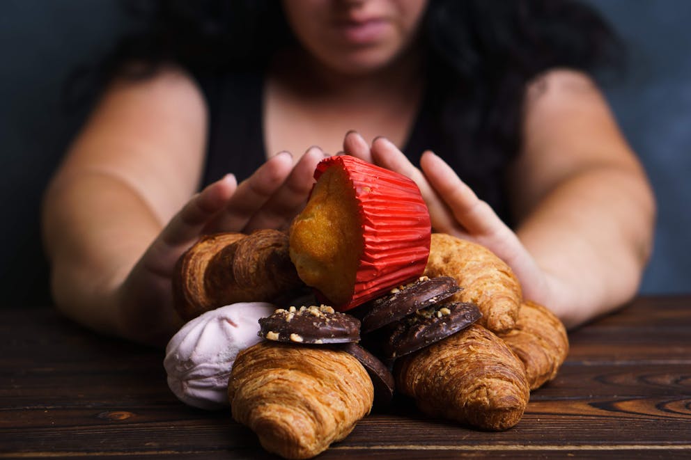 Woman declining sugary foods