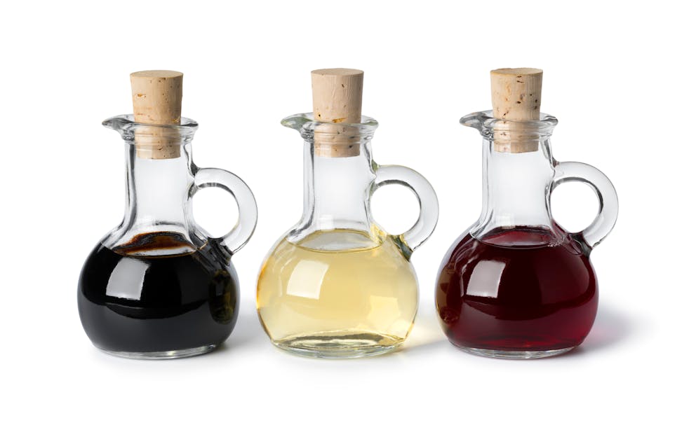 Three kinds of vinegar in glass bottles
