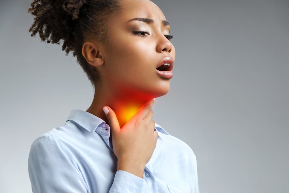 Woman with sore throat symptoms