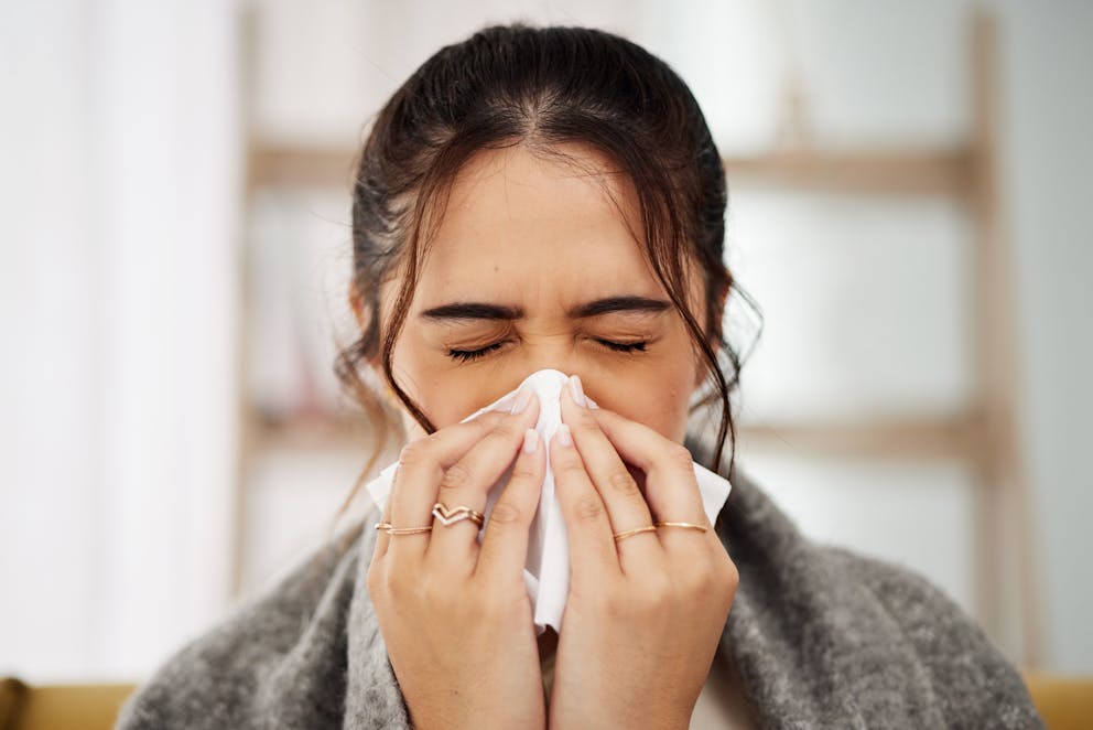 Woman blowing nose sinus infection