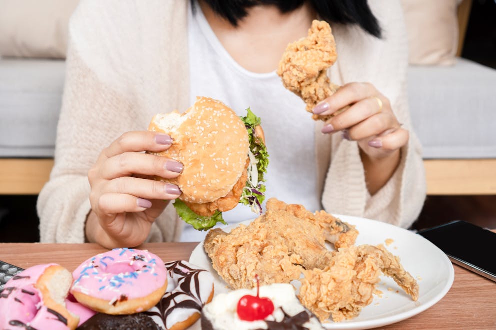 Women binge eating unhealthy food