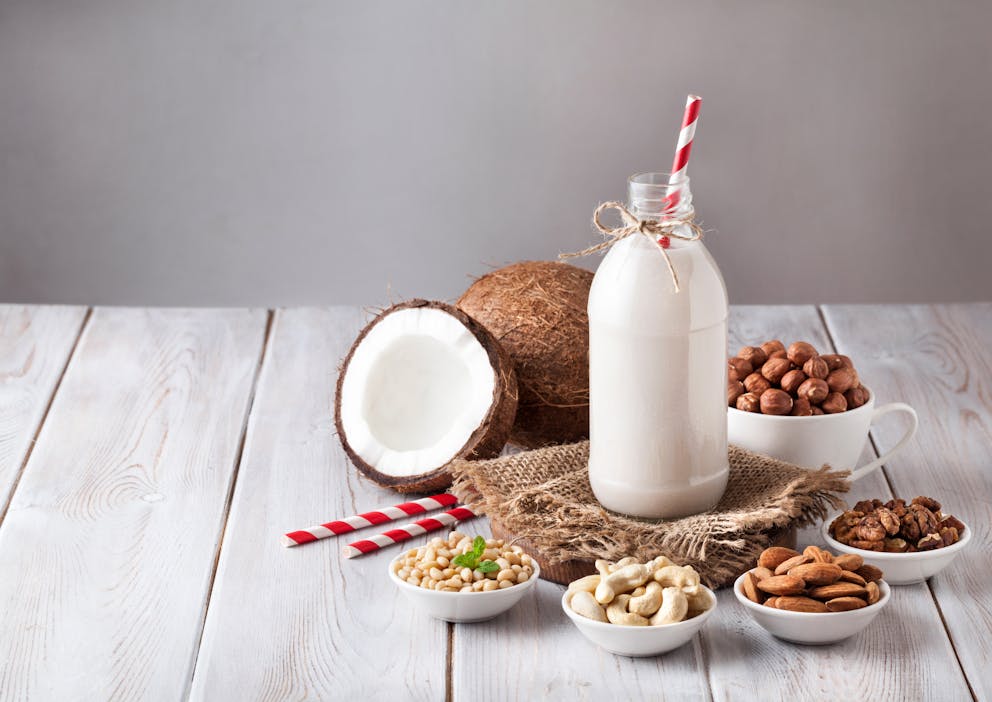 Bottle of milk and selection of nuts on a table