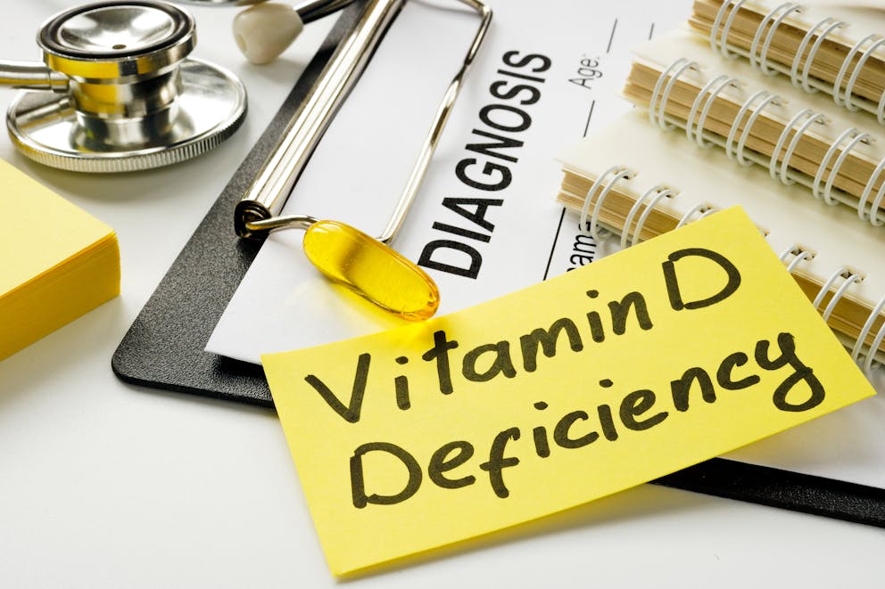 Vitamin D deficiency diagnosis with empty medical form.