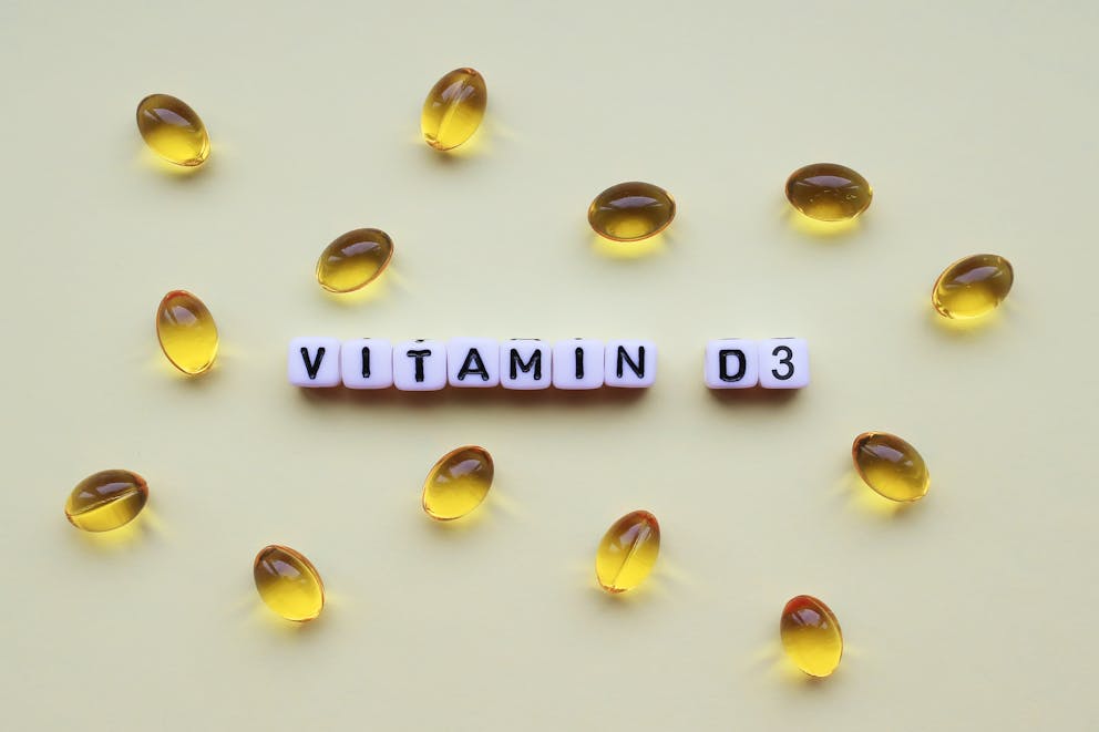 Vitamin D3 gel capsules on a light background.