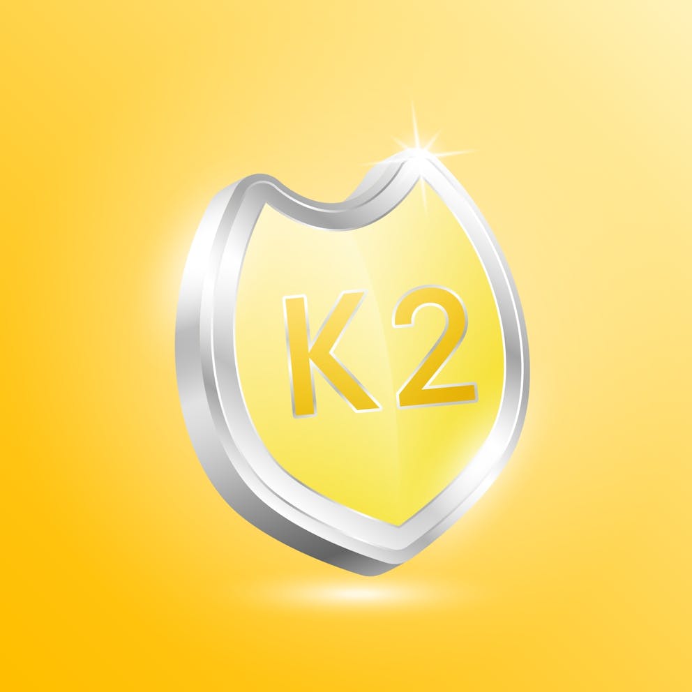 Vitamin K2 shield protected guard isolated on yellow background.