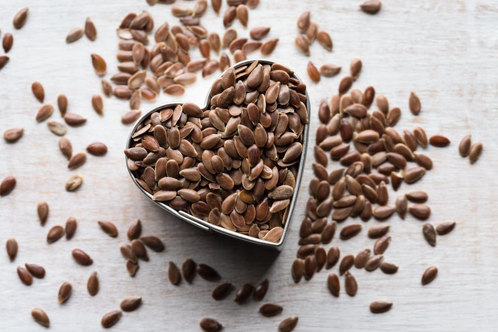 Flaxseeds in a heart-shaped tin