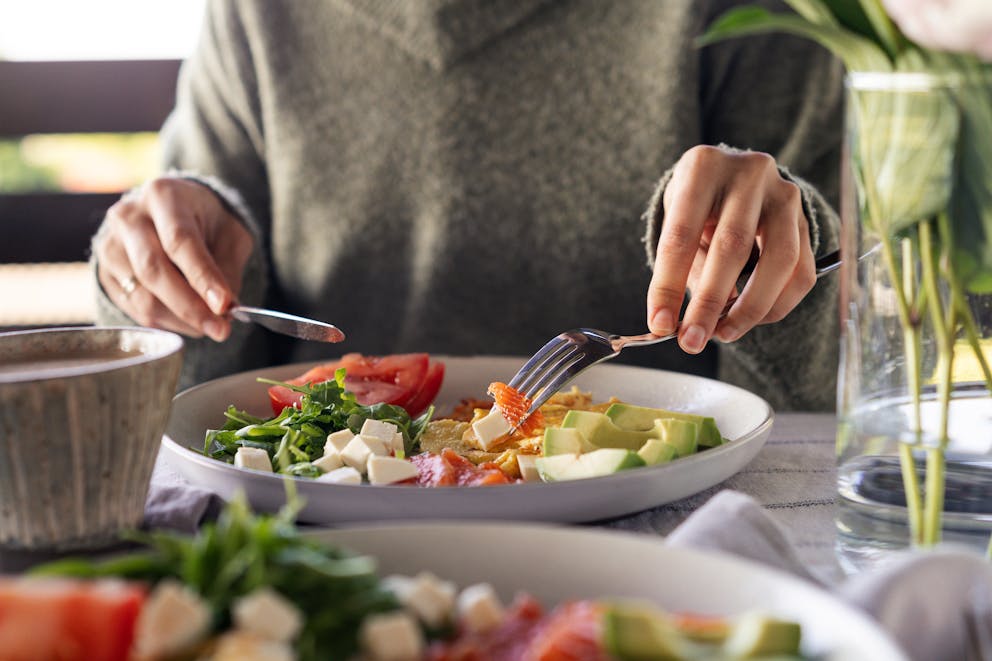 Woman eating healthy keto salad