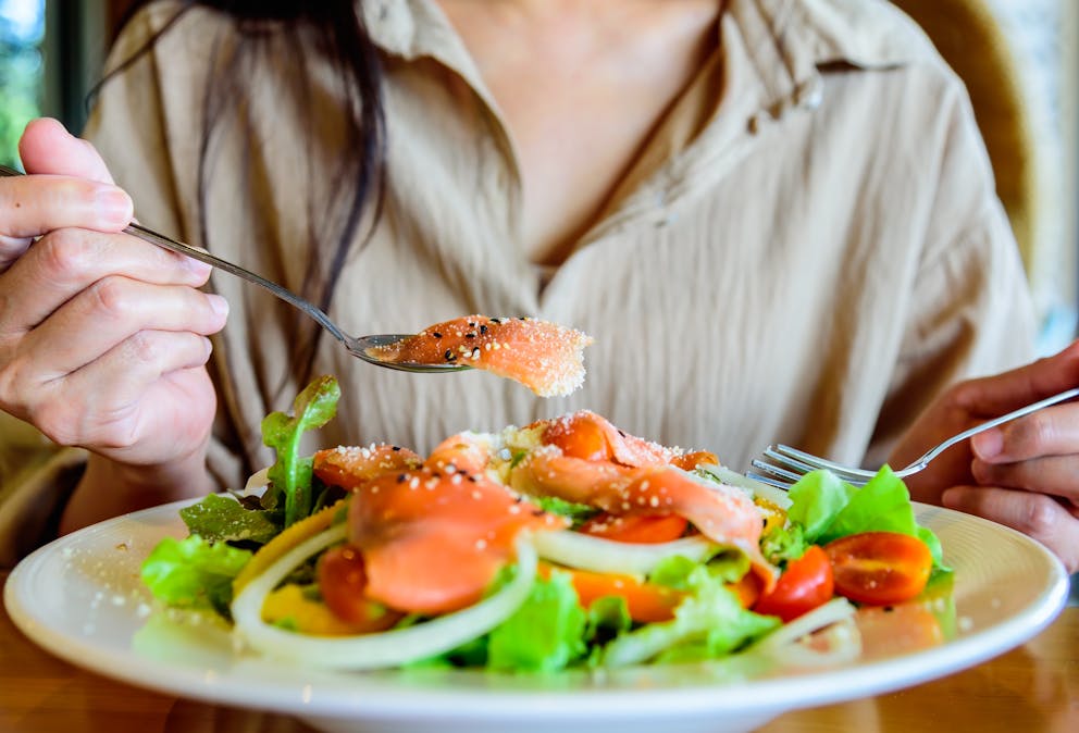 Woman eating salmon