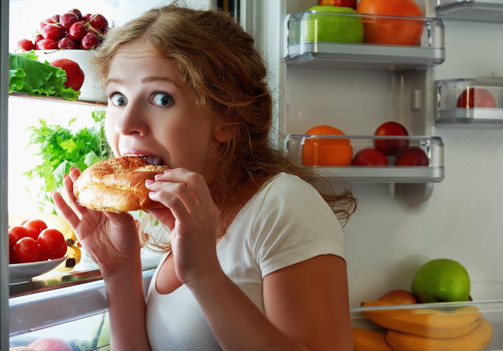 Woman sneaking food