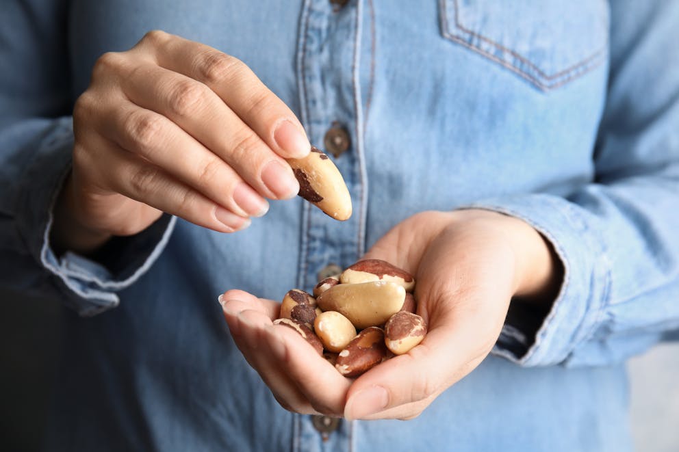 Woman holding Brazil nuts