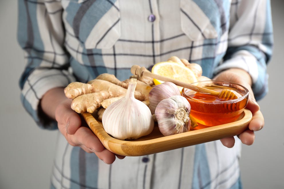 Woman holding tray with antibacterial foods