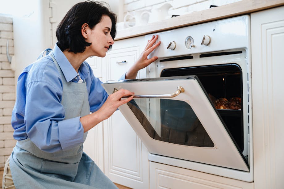 Woman opening oven