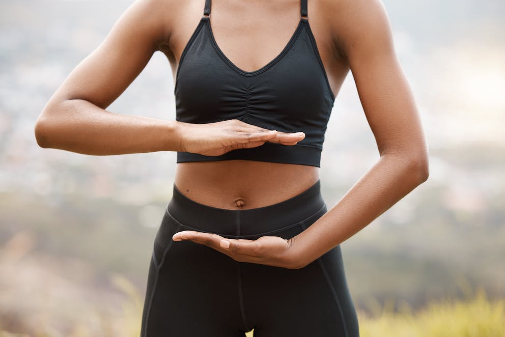 Woman holding hands on stomach