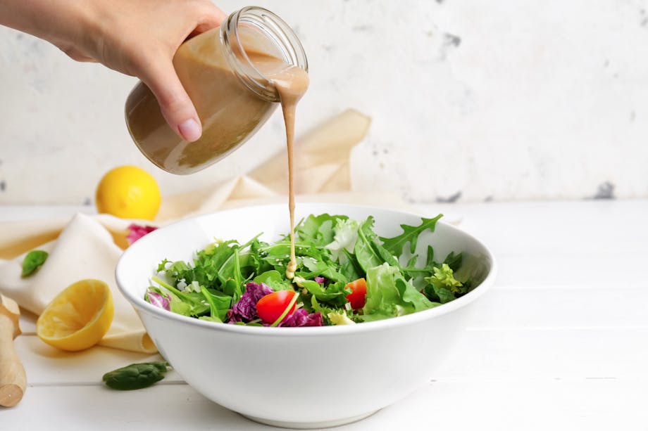 Pouring tahini in salad