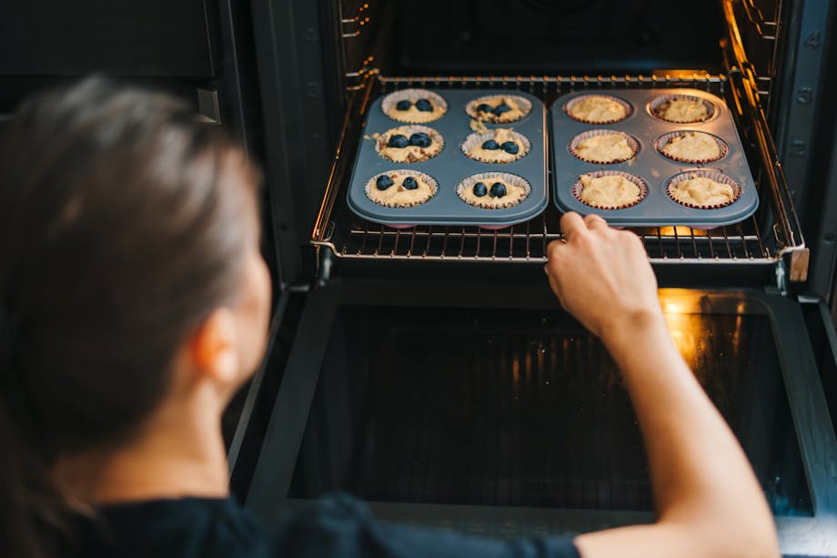 Woman baking blueberry muffins