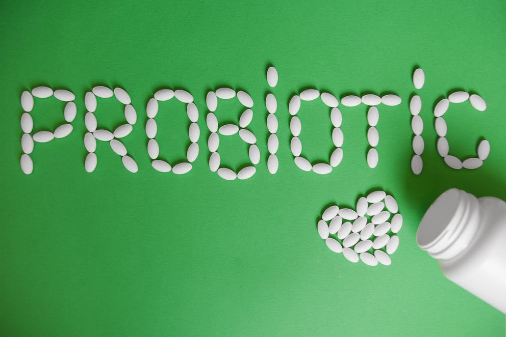 Probiotic supplements on green background