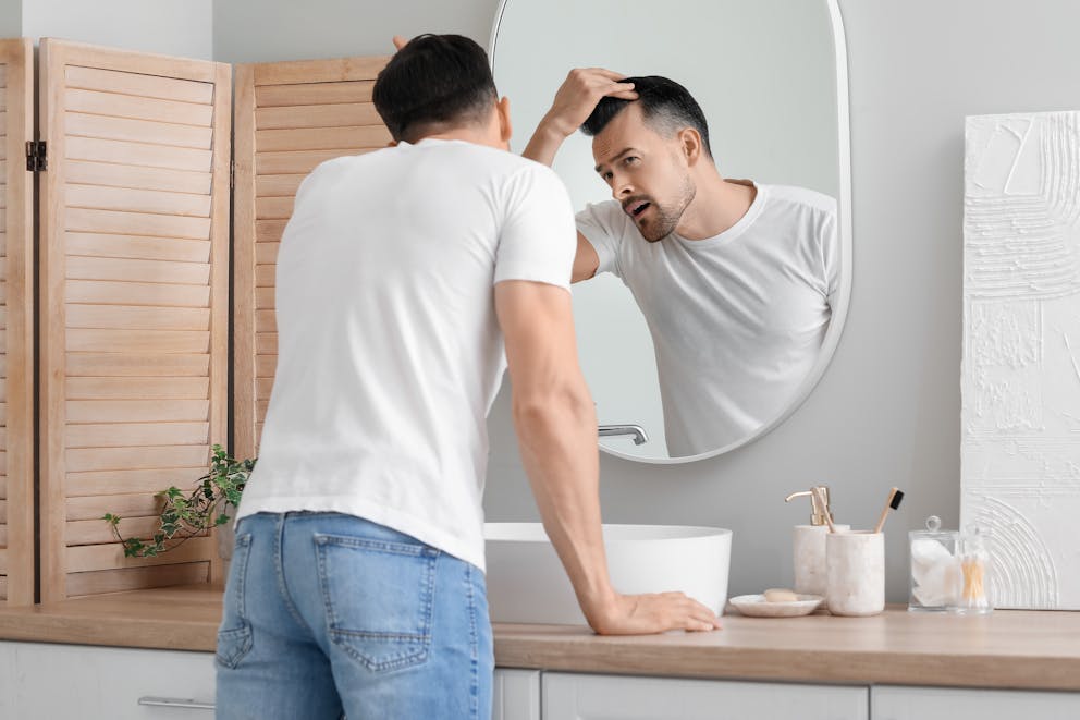 Man checking his hairline