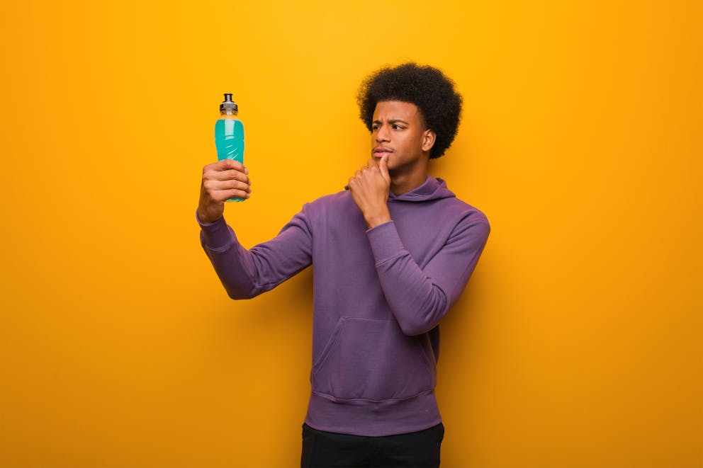 Young man questioning sports drink