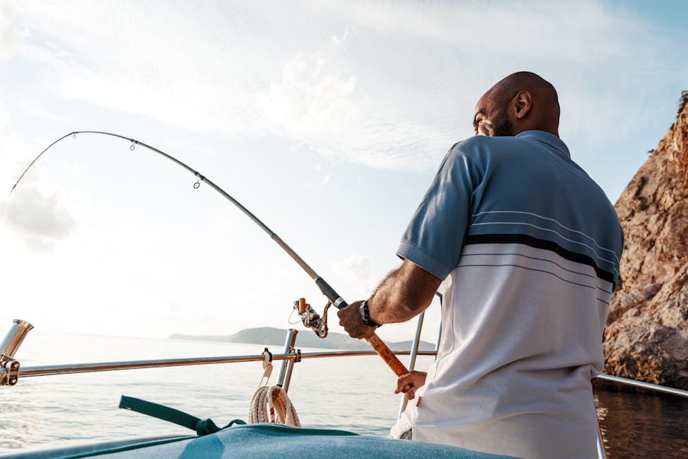 Young man fishing in the ocean