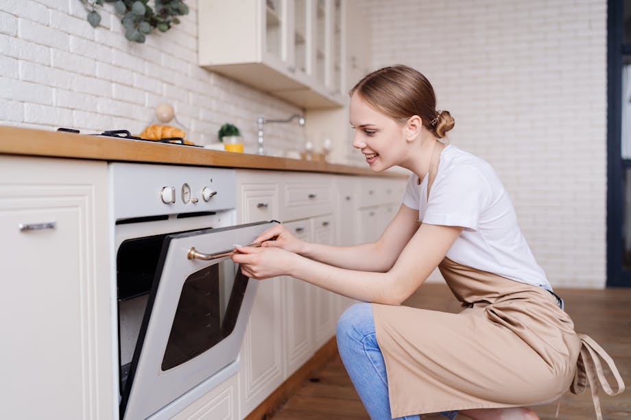 Woman opening oven