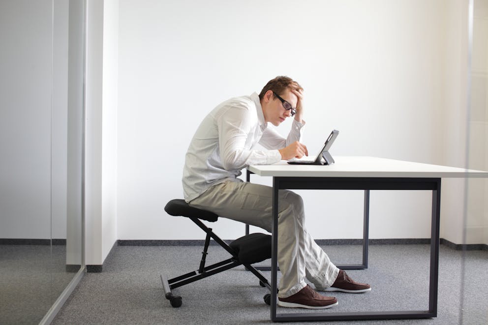 Man slouching over a computer