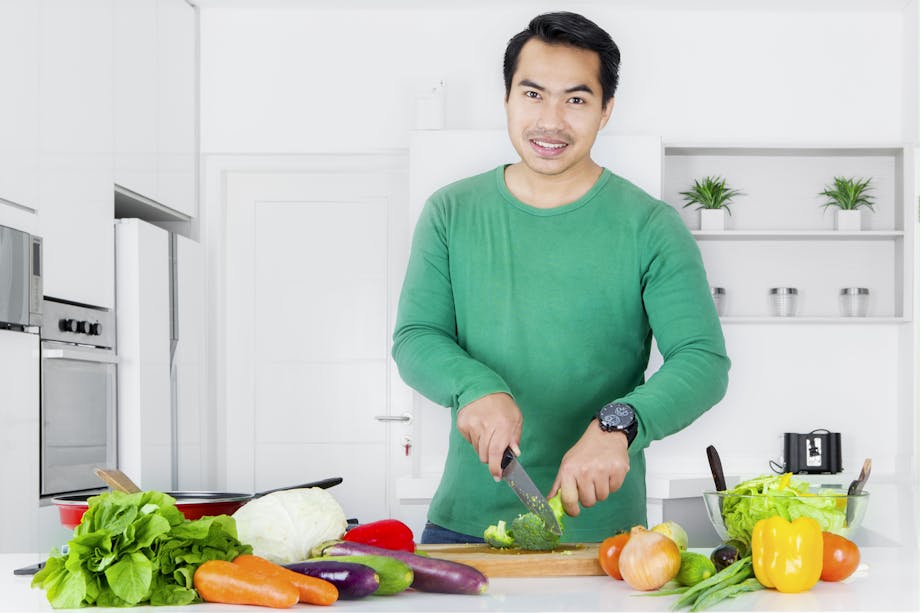 Man cutting broccoli