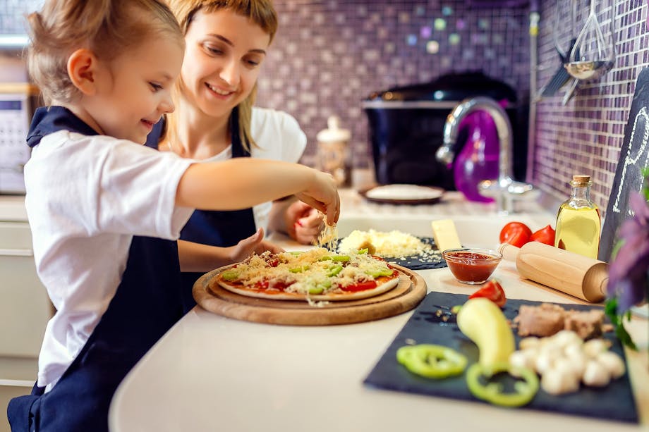 Mother and daughter making pizza