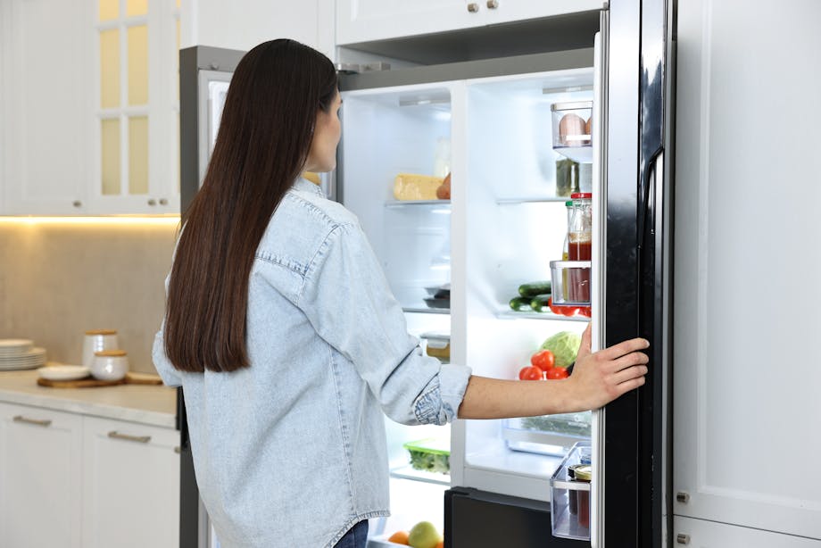 Woman opening fridge