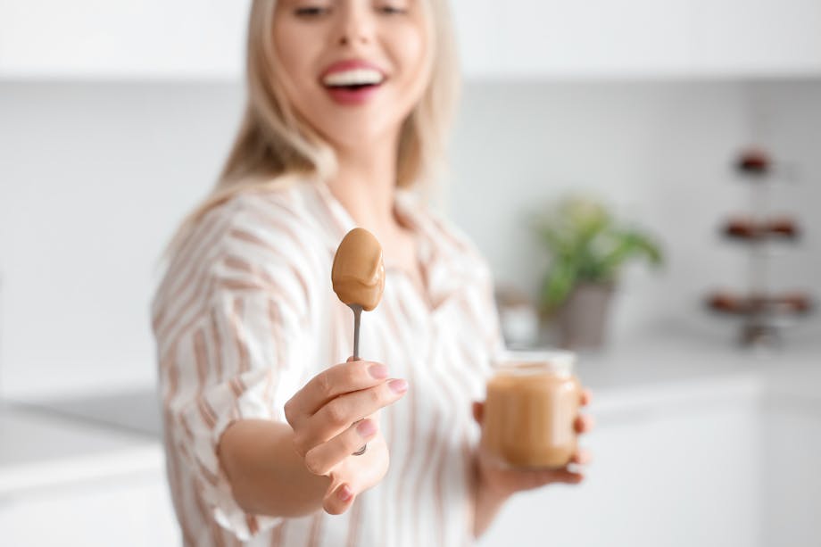 holding the spoon of peanut butter